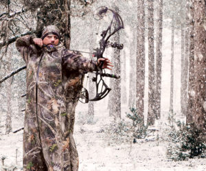Bow hunter using Blizzard Buddy cold weather hunting suit