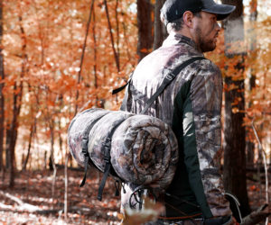 Cold weather hunting suit with carrying straps